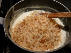 Stir the hash browns into the sour cream sauce.